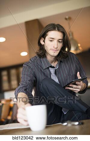 Caucasian businessman reaching for cup of coffee View Large Photo Image Stock Image - Caucasian businessman reaching for cup of coffee. Fotosearch