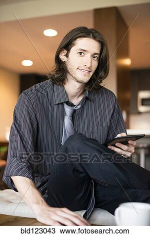Stock Image - Caucasian businessman using digital tablet. Fotosearch