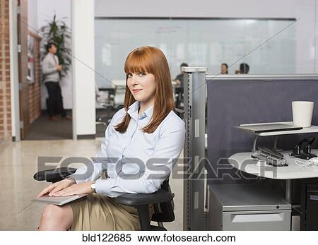 Caucasian businesswoman smiling in office View Large Photo Image Stock Photography - Caucasian businesswoman smiling in office. Fotosearch