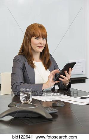 Caucasian businesswoman using digital tablet in office View Large Photo Image Stock Image - Caucasian businesswoman using digital tablet in office. Fotosearch