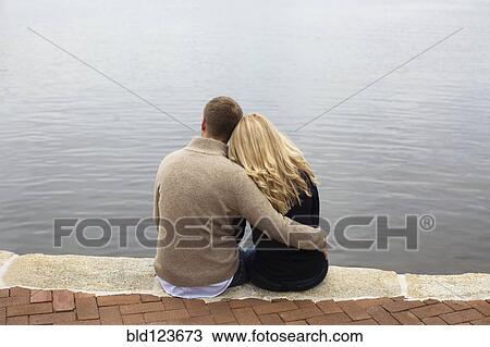 Caucasian couple hugging by lake View Large Photo Image Stock Image - Caucasian couple hugging by lake. Fotosearch