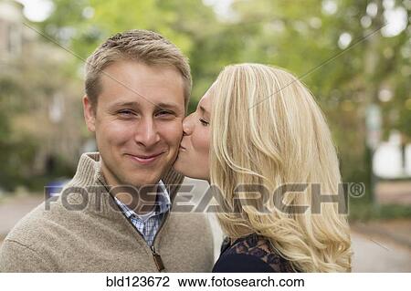 Caucasian couple kissing outdoors View Large Photo Image Stock Image - Caucasian couple kissing outdoors. Fotosearch