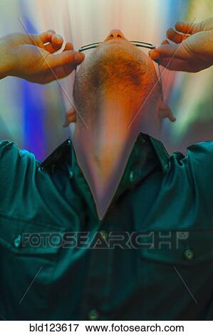 Stock Photo - Caucasian man looking through glasses. Fotosearch
