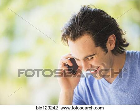 Stock Image - Caucasian man talking on cell phone. Fotosearch