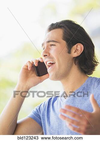 Stock Image - Caucasian man talking on cell phone. Fotosearch