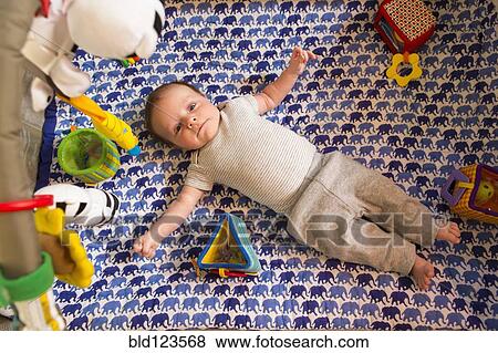 Caucasian newborn laying in crib View Large Photo Image Stock Photo - Caucasian newborn laying in crib. Fotosearch