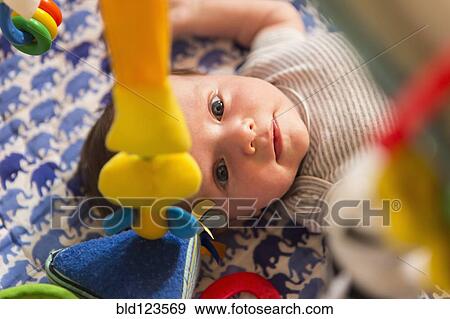 Stock Photo - Caucasian newborn laying in crib. Fotosearch