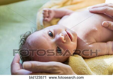 Stock Image - Caucasian newborn laying on towel. Fotosearch