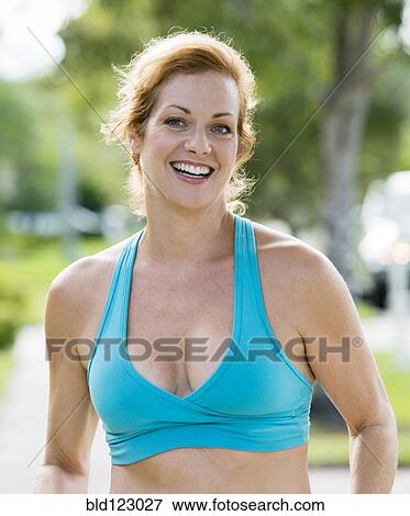 Stock Photo - Caucasian woman in sports-bra outdoors. Fotosearch