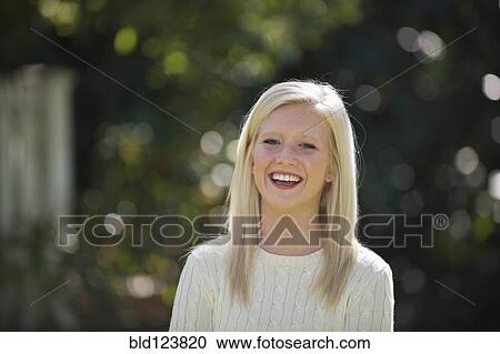 Stock Image - Caucasian woman smiling outdoors. Fotosearch