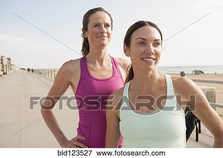 Caucasian women in sportswear at beach boardwalk View Large Photo Image Stock Photo - Caucasian women in sportswear at beach boardwalk. Fotosearch