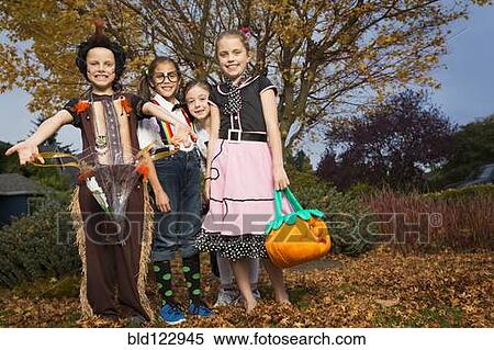 Children in Halloween costumes under autumn tree View Large Photo Image Stock Photography - Children in Halloween costumes under autumn tree. Fotosearch