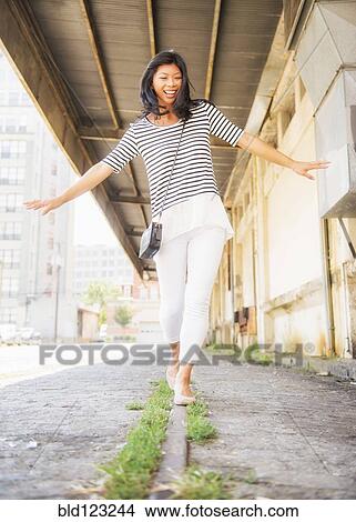 Chinese woman walking on urban street View Large Photo Image Picture - Chinese woman walking on urban street. Fotosearch