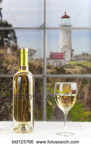 Close up of bottle of wine and glass on table View Large Photo Image Stock Photograph - Close up of bottle of wine and glass on table. Fotosearch