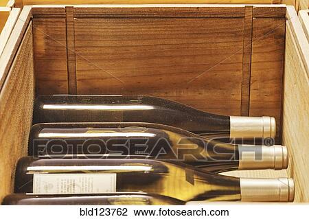 Stock Image - Close up of crates of wine bottles. Fotosearch