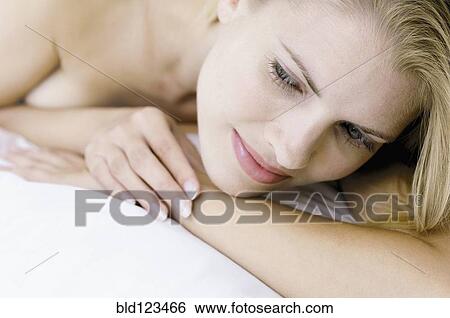 Stock Photograph - Close up of woman laying on bed. Fotosearch