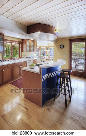 Stock Image - Counter tops and stools in open kitchen. Fotosearch