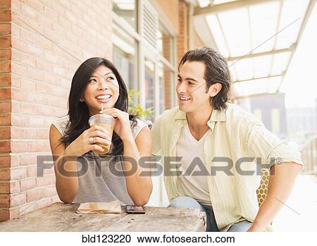 Couple enjoying iced coffee at sidewalk cafe View Large Photo Image Stock Image - Couple enjoying iced coffee at sidewalk cafe. Fotosearch