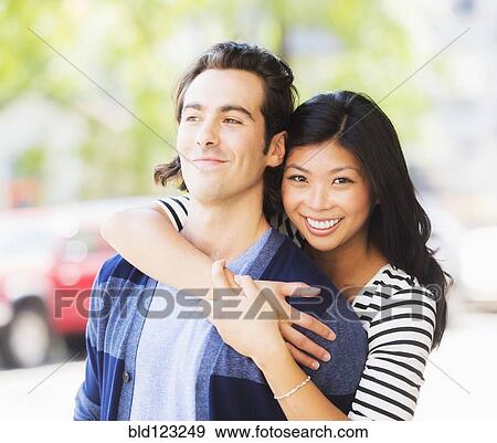 Couple hugging on urban street View Large Photo Image Stock Photo - Couple hugging on urban street. Fotosearch