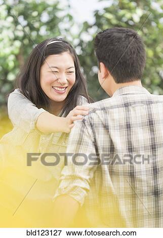 Couple relaxing in park View Large Photo Image Stock Photo - Couple relaxing in park. Fotosearch