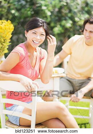 Couple relaxing together outdoors View Large Photo Image Stock Image - Couple relaxing together outdoors. Fotosearch
