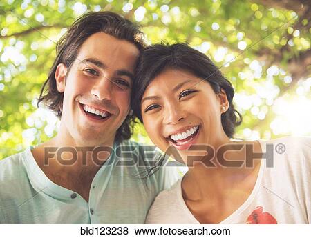 Stock Photo - Couple smiling outdoors. Fotosearch