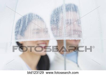 Couple together under umbrella View Large Photo Image Stock Photo - Couple together under umbrella. Fotosearch