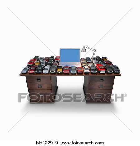 Desk with laptop and model cars View Large Photo Image Stock Photo - Desk with laptop and model cars. Fotosearch