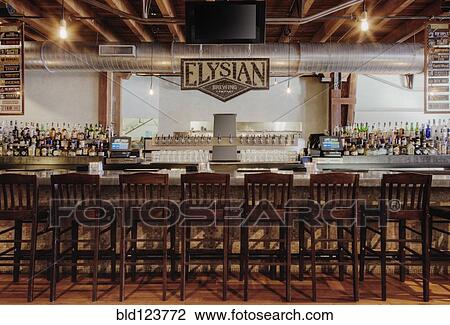 Stock Image - Elysian Brewing sing over bar. Fotosearch