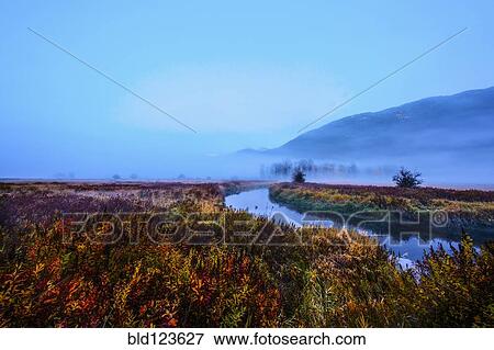 Stock Photo - Fog over river and rural landscape. Fotosearch