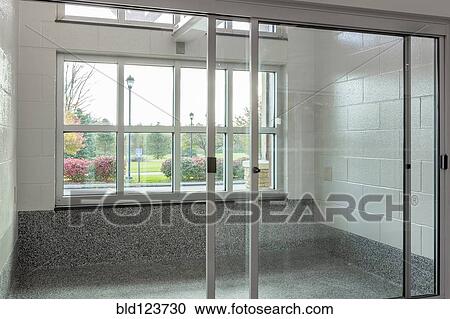 Stock Image - Glass doors to holding area in animal shelter. Fotosearch