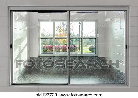 Glass doors to holding area in animal shelter View Large Photo Image Stock Photo - Glass doors to holding area in animal shelter. Fotosearch
