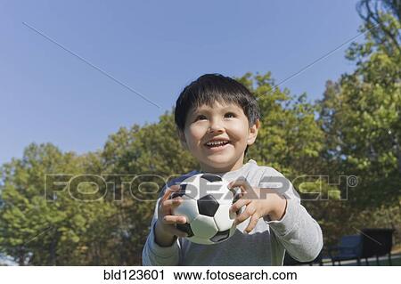 Hispanic boy playing soccer outdoors View Large Photo Image Stock Image - Hispanic boy playing soccer outdoors. Fotosearch