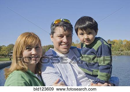 Hispanic family smiling at lakeside View Large Photo Image Stock Photo - Hispanic family smiling at lakeside. Fotosearch