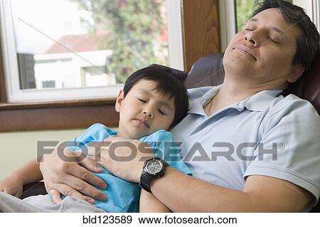 Stock Photo - Hispanic father and son napping. Fotosearch