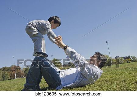 Download Hispanic father and son playing outdoors Stock Photography ...