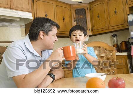 Hispanic father and son toasting each other View Large Photo Image Stock Image - Hispanic father and son toasting each other. Fotosearch