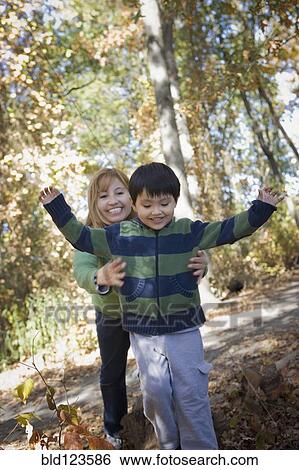 Hispanic mother and son playing in park View Large Photo Image Stock Photograph - Hispanic mother and son playing in park. Fotosearch