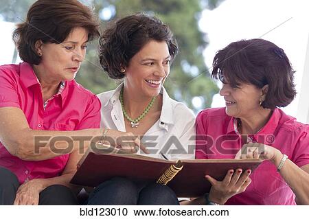 Hispanic women looking at photograph album View Large Photo Image Stock Image - Hispanic women looking at photograph album. Fotosearch