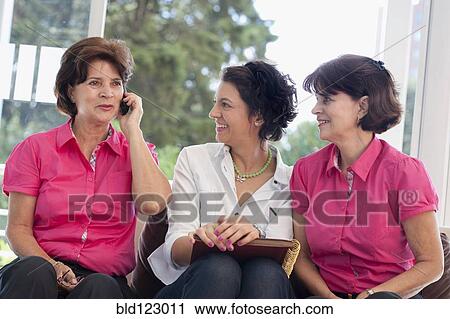 Stock Image - Hispanic women talking on cell phone. Fotosearch