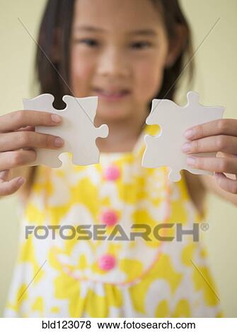 Korean girl connecting jigsaw pieces View Large Photo Image Stock Photo - Korean girl connecting jigsaw pieces. Fotosearch