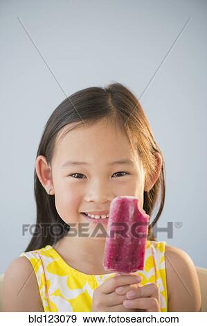 Stock Photo - Korean girl eating flavored ice. Fotosearch