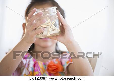 Korean girl examining starfish in jar View Large Photo Image Stock Photo - Korean girl examining starfish in jar. Fotosearch