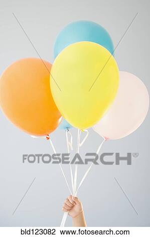 Korean girl holding bunch of balloons View Large Photo Image Stock Image - Korean girl holding bunch of balloons. Fotosearch