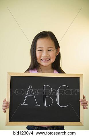Korean girl holding chalkboard with ABC text View Large Photo Image Picture - Korean girl holding chalkboard with ABC text. Fotosearch