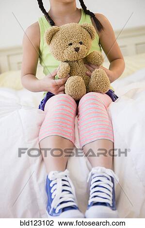 Korean girl holding teddy bear on bed View Large Photo Image Stock Image - Korean girl holding teddy bear on bed. Fotosearch