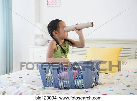 Korean girl looking through cardboard tube View Large Photo Image Picture - Korean girl looking through cardboard tube. Fotosearch