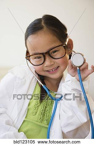 Stock Photography - Korean girl playing doctor. Fotosearch