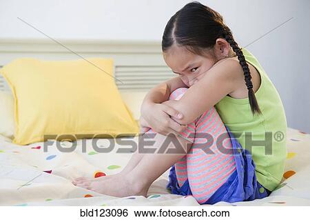 Korean girl pouting on bed View Large Photo Image Stock Photograph - Korean girl pouting on bed. Fotosearch