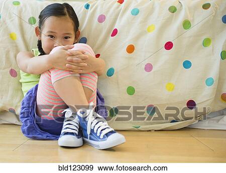 Korean girl sitting on bedroom floor View Large Photo Image Stock Photo - Korean girl sitting on bedroom floor. Fotosearch